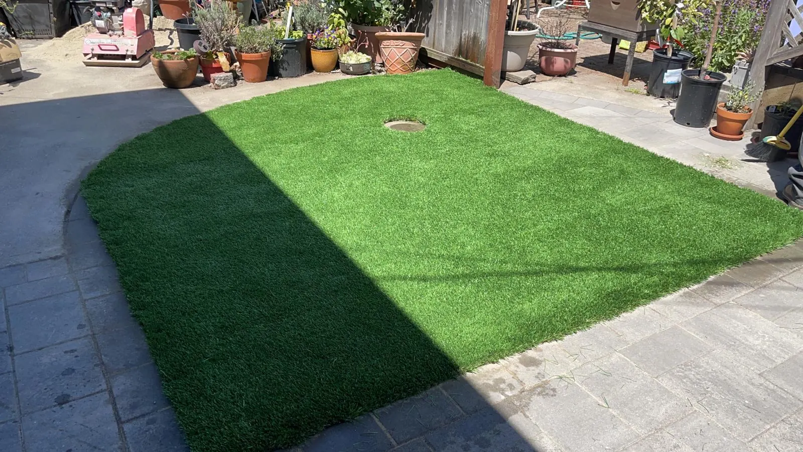 Artificial turf lawn framed by a concrete paver border