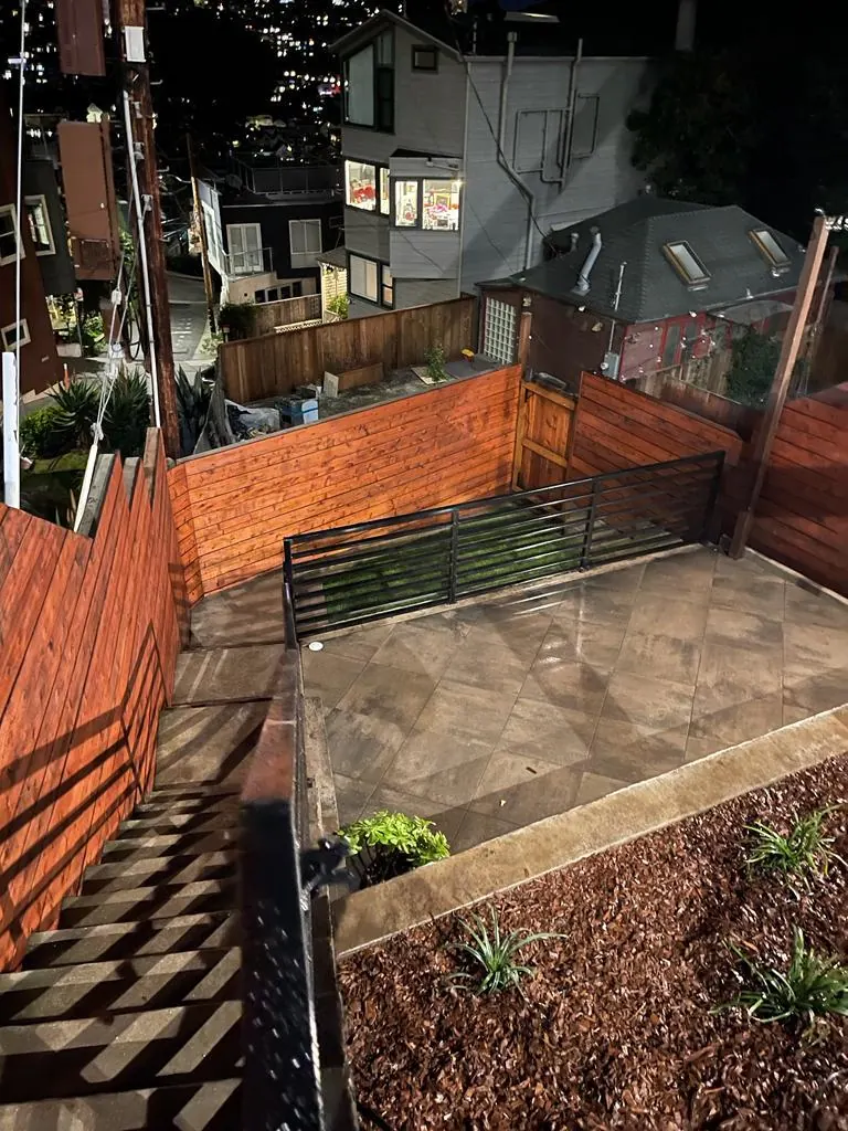 Backyard patio and stairs with a new horizontal wood fence