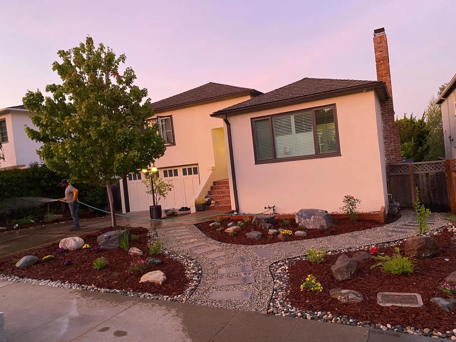 Front yard landscaping with river rock, mulch and boulders