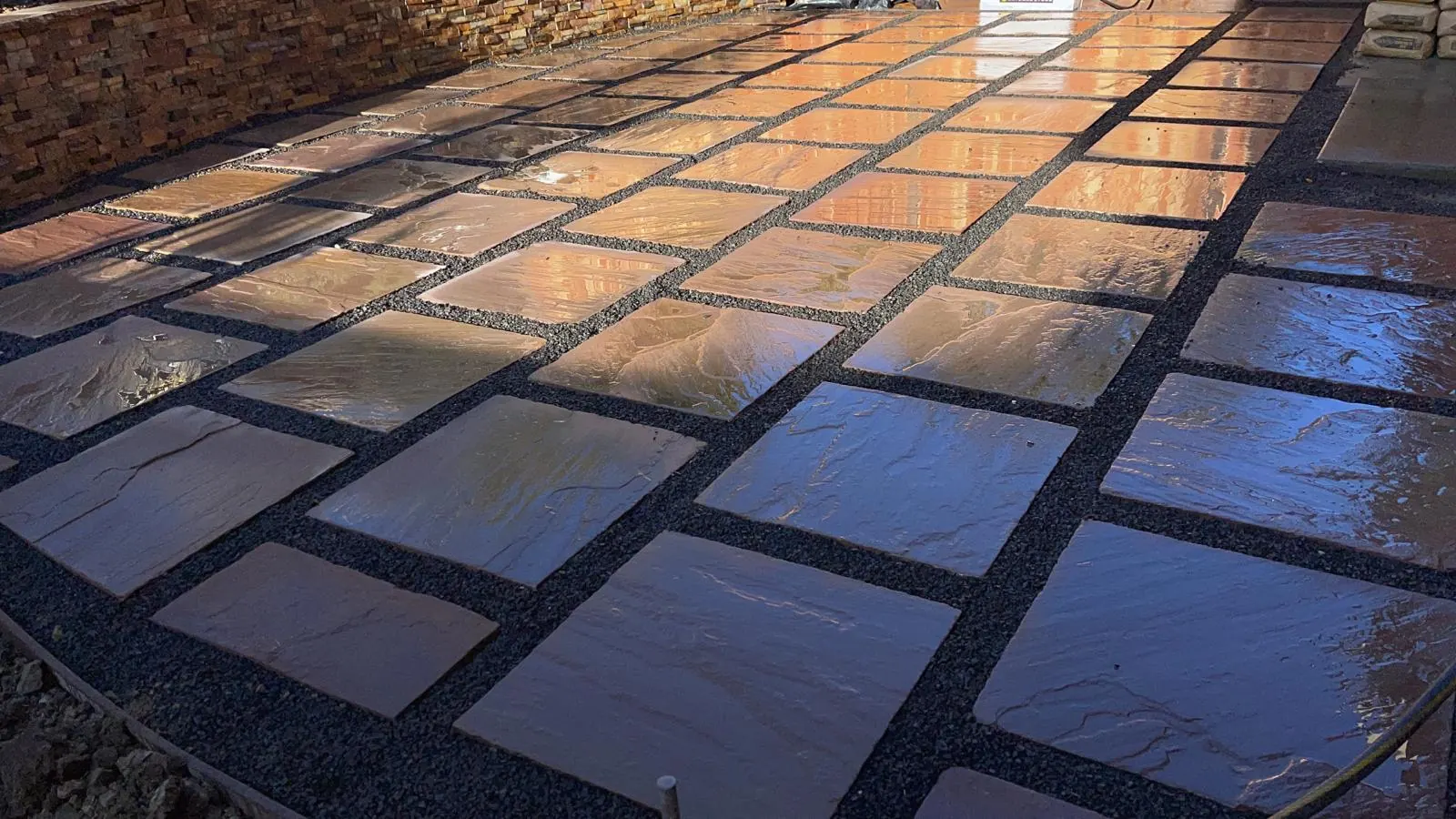 Large format pavers with gravel joints after rain