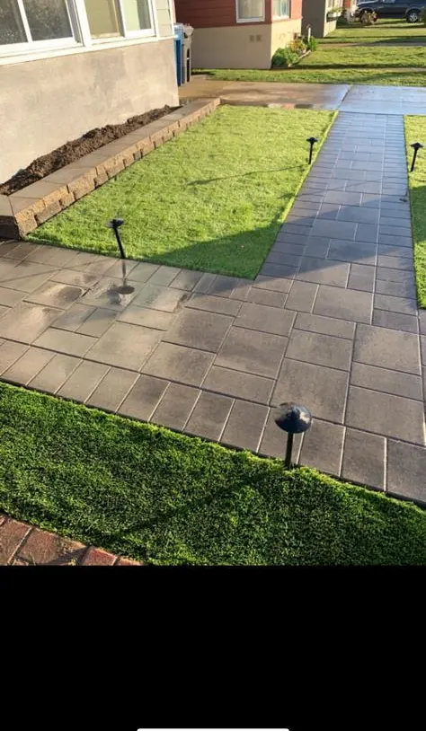 Paver walkway running between two strips of artificial turf